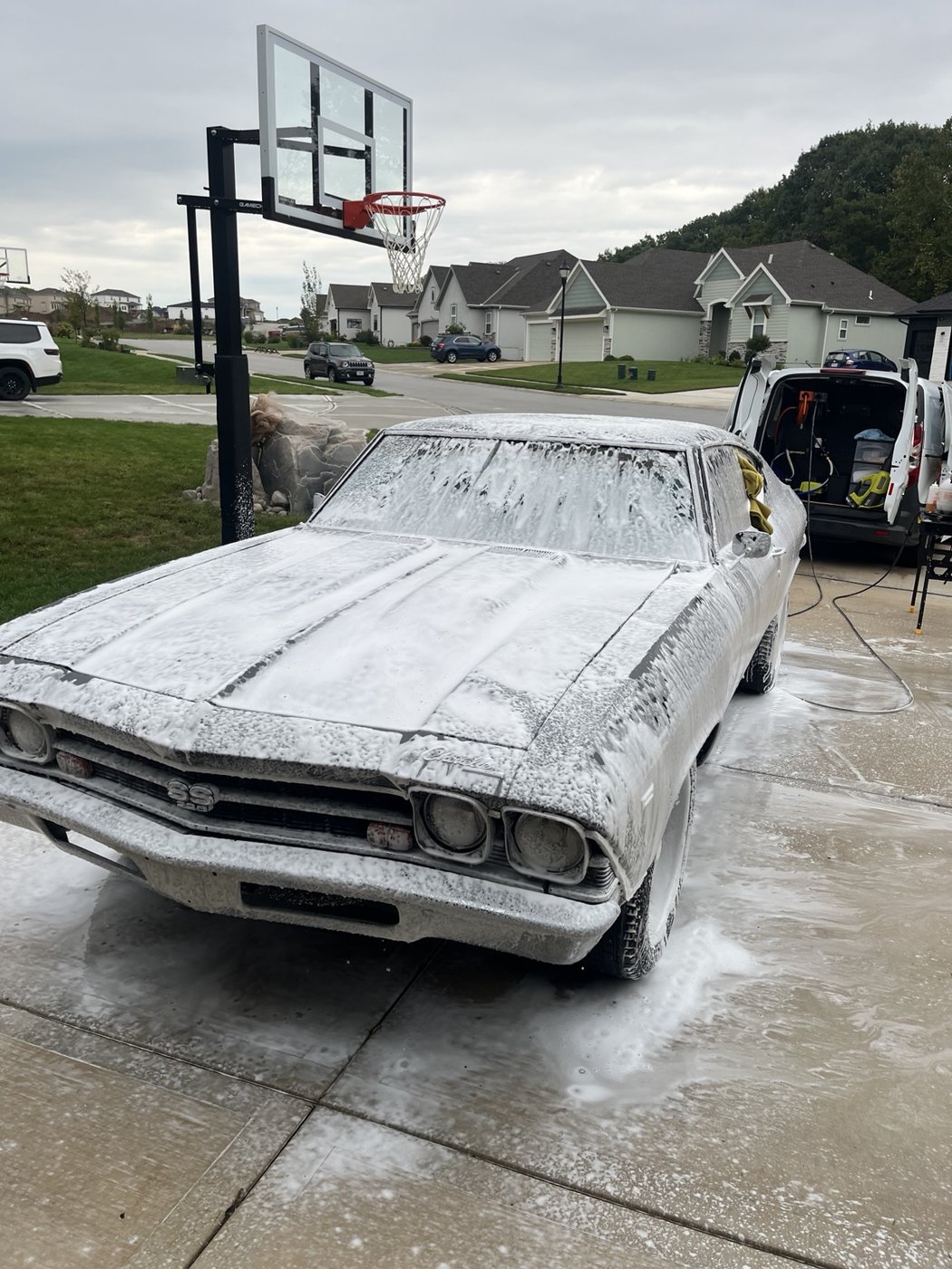 Classic car receiving an exterior foam wash